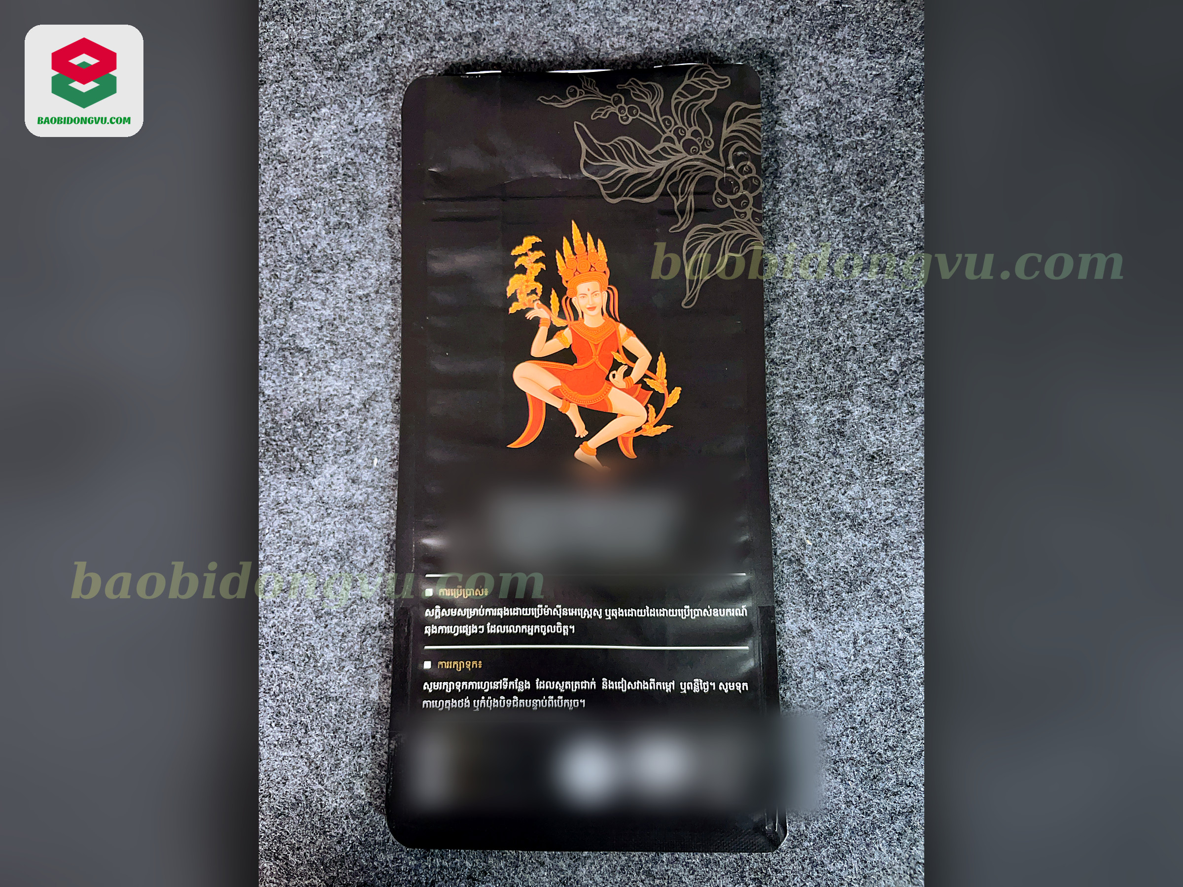 Matte black flat-bottom coffee bag with gold and orange artwork, custom printed by Dong Vu Packaging in Vietnam