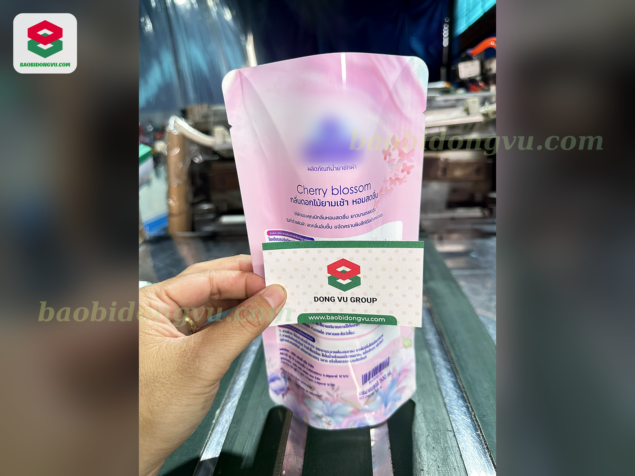 Pink fabric softener spout pouch held at the bag-making line in the Dong Vu Packaging factory, Ho Chi Minh City